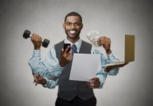 blog image business man with six arms holding money, laptop, paper, phone, pen, and weight