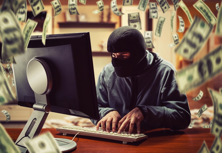Blog image Hacker in mask stealing information and money at home