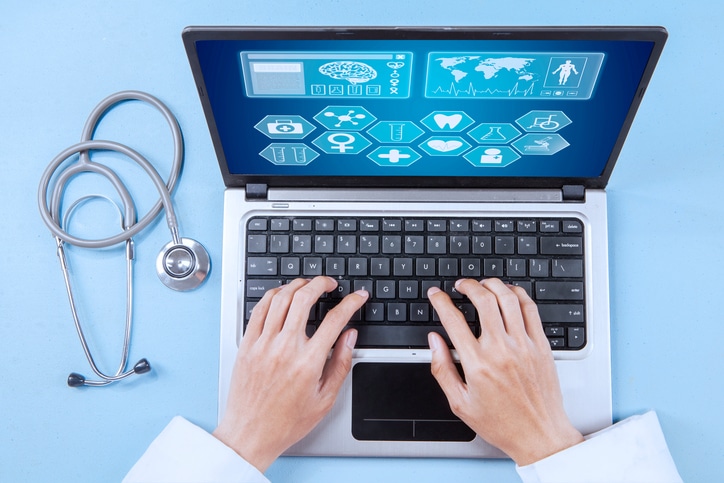 Blog image Close up of male doctor working on a laptop for analyzing human illness