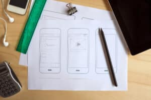 Blog image papers with sketches of a phone on a desk