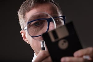 Blog image man checking data with a magnifier