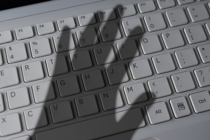 Blog image shadow of a hand over a white keyboard