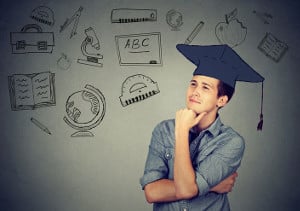 blog image man with gradation cap looking off into the distance with background of hand draw symbols of school subjects