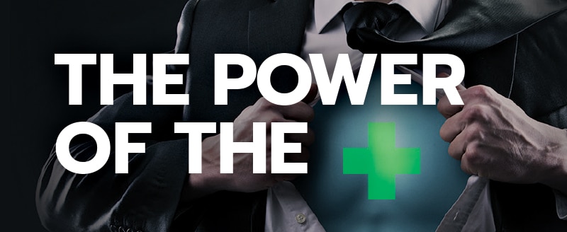 Business man opening shirt with green cross of chest with white text of the power of the +