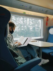 man working on laptop on train - remote desktop services