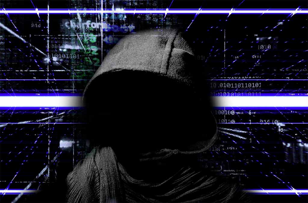 ransomware - man in hoodie on coding background