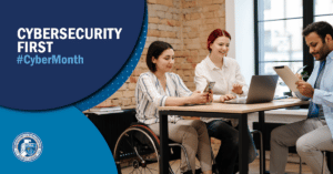 Three people around table using laptop and cell phone