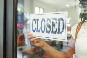 Employee hanging closed sign