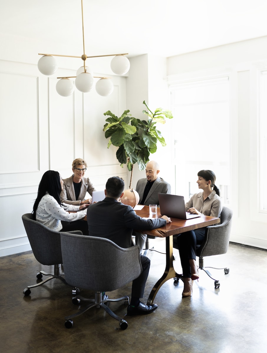 Business people around desk at meeting