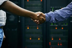 Shaking hands in server room