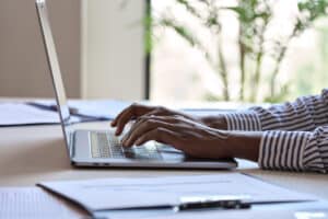 female employee on work computer at desk practicing email security