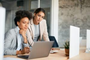 female coworkers on computer figuring out ai cybersecurity protocols