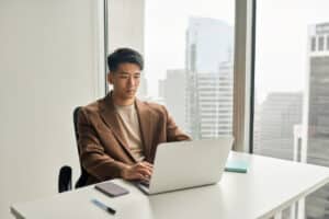 businessman working on computer, learning about how to avoid top cybersecurity risks