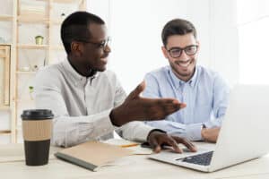 two businessmen working on computer using cybersecurity professional services