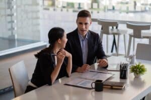 coworkers in office discussing security plan for their business